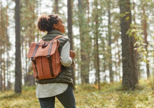 woman hiking through the woods